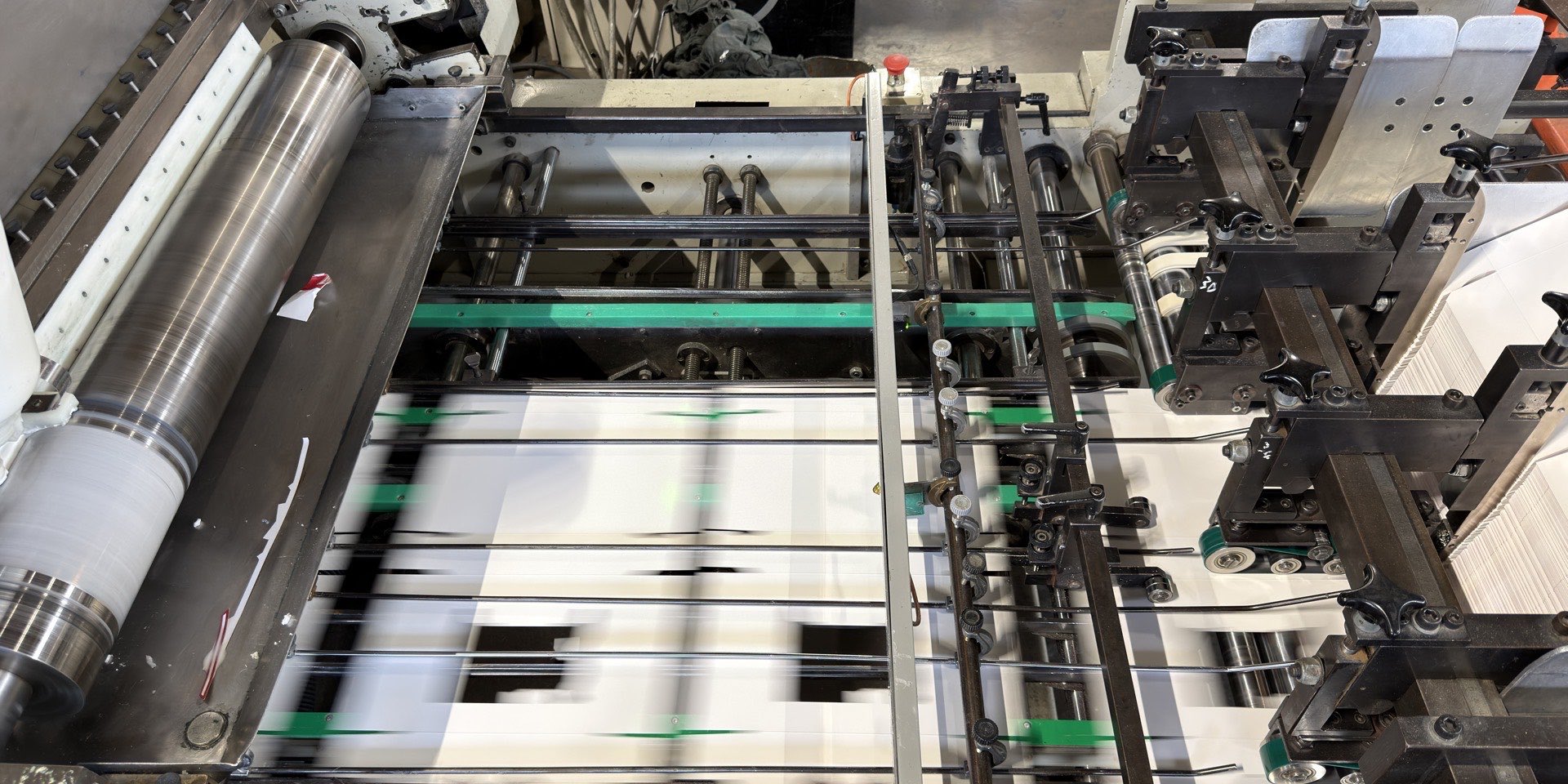 Folding cartons running through the folder gluer line at the Carton-Pro factory in Peterborough